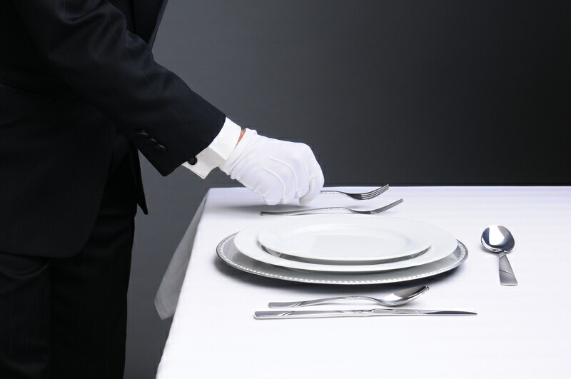 Waiter using white glovess